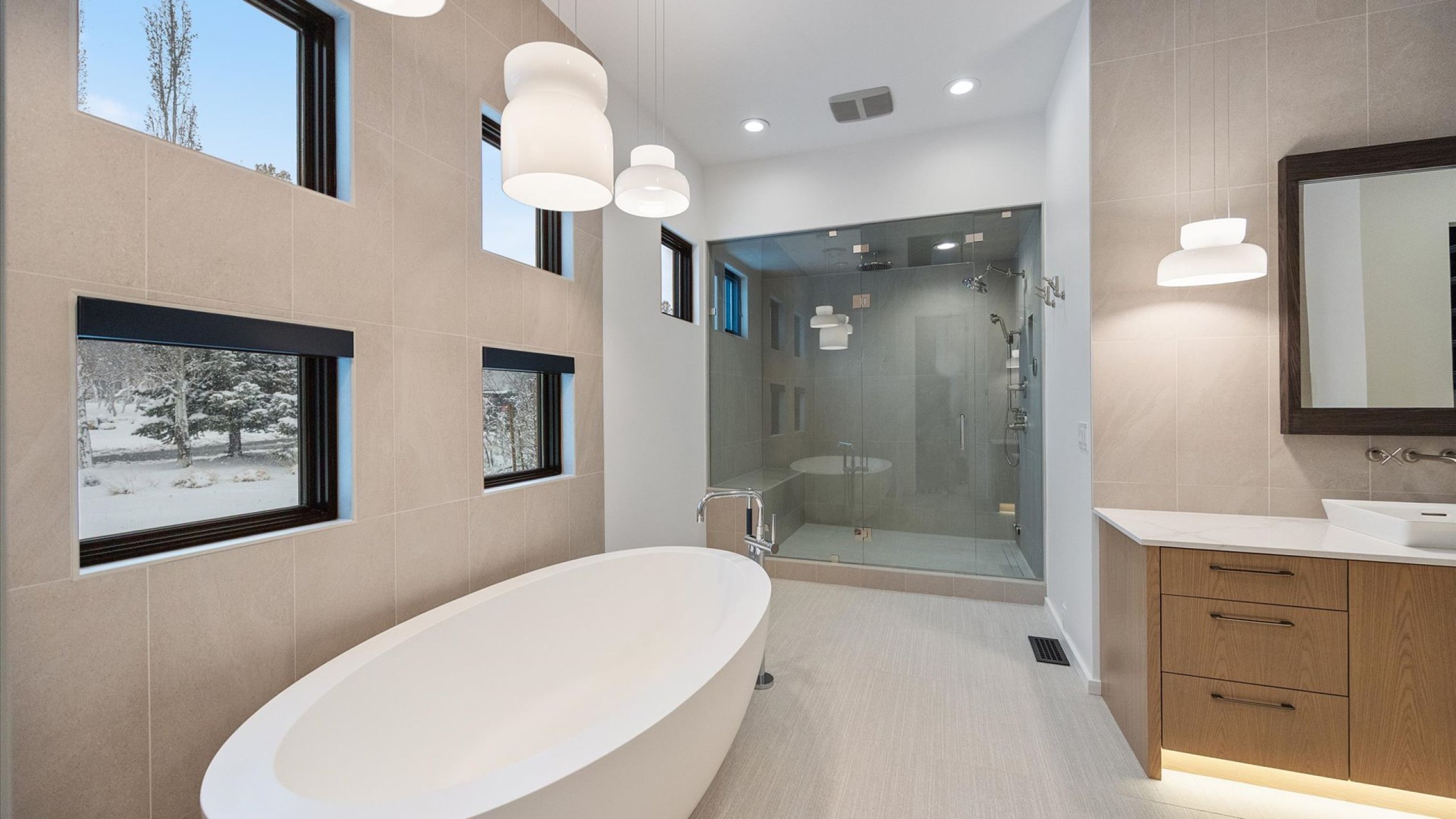 Full bath with tile walls, a soaking tub, a shower stall, and vanity