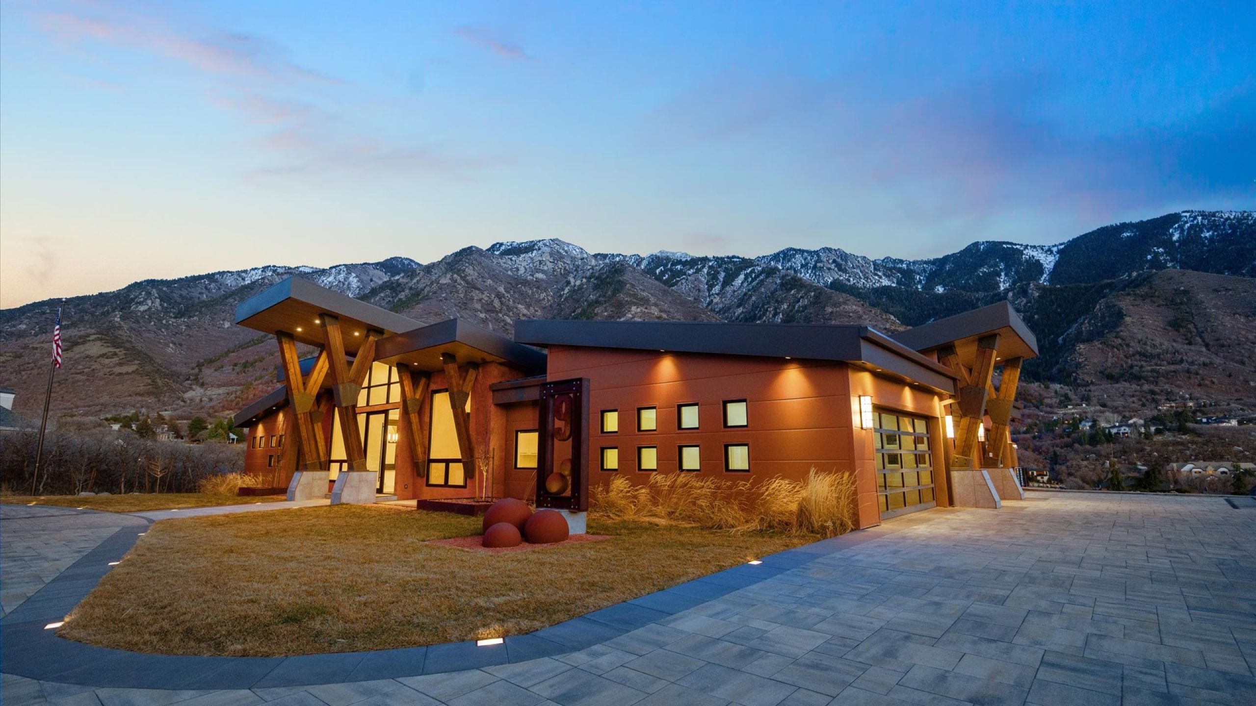 Modern home featuring a mountain view, driveway, yard and garage