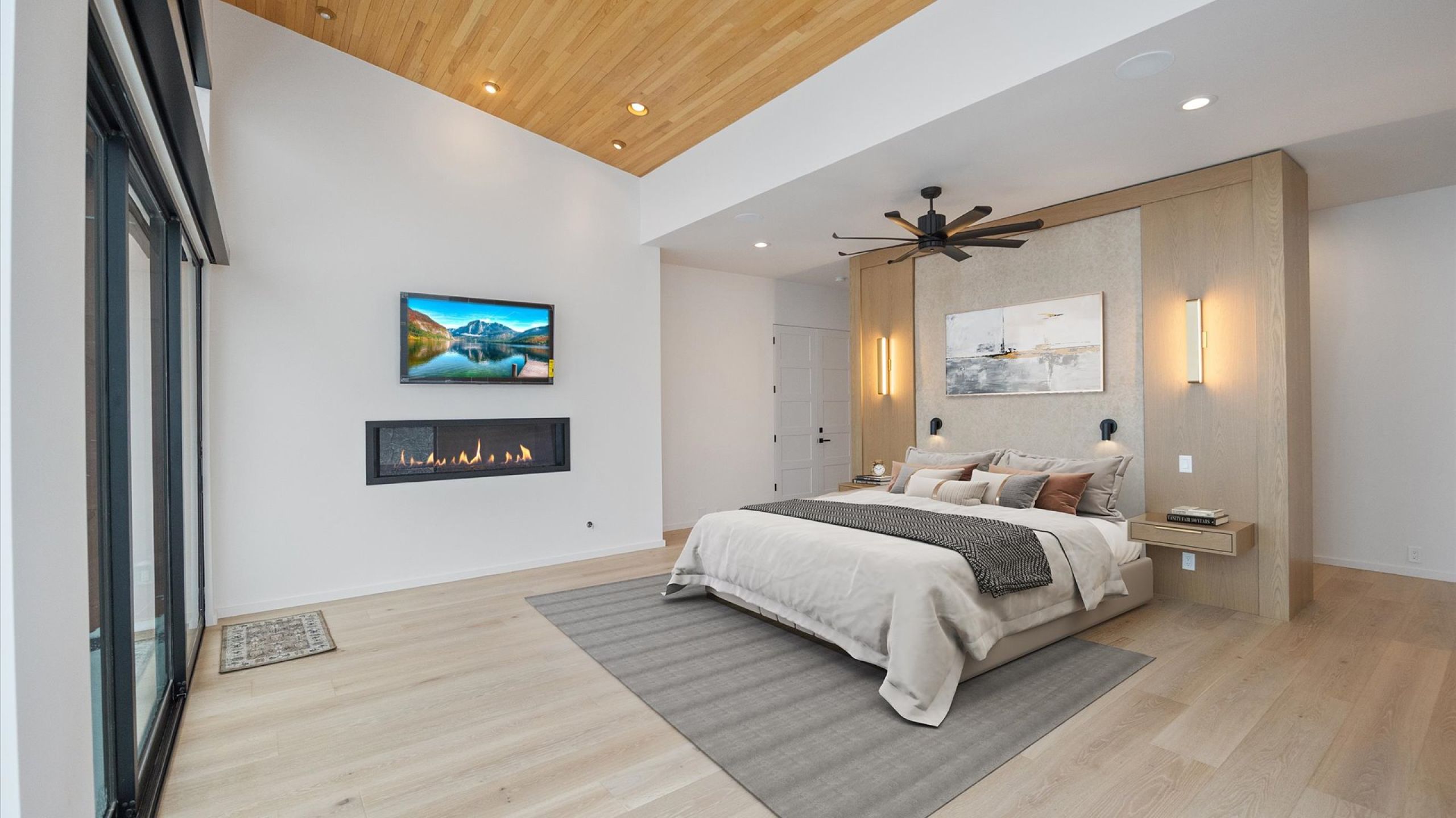 Bedroom with a glass covered fireplace, light wood finished floors, wooden ceiling, recessed lighting, and ceiling fan